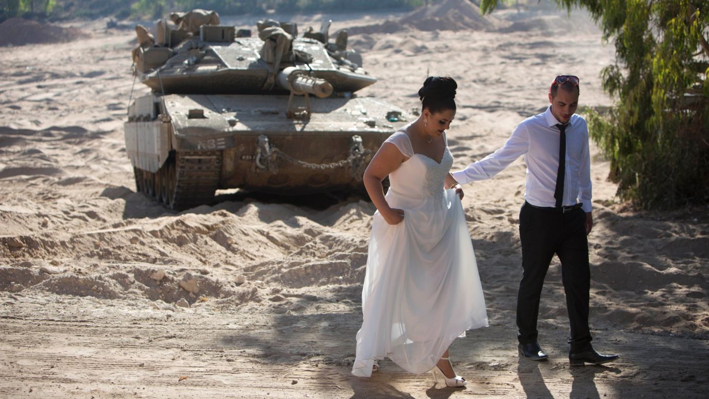 Israeli couple Noga and Moshiko Siho leave an army staging area after having their wedding photos taken near the Yad Mordechai kibbutz in Israel on Wednesday, August 27.