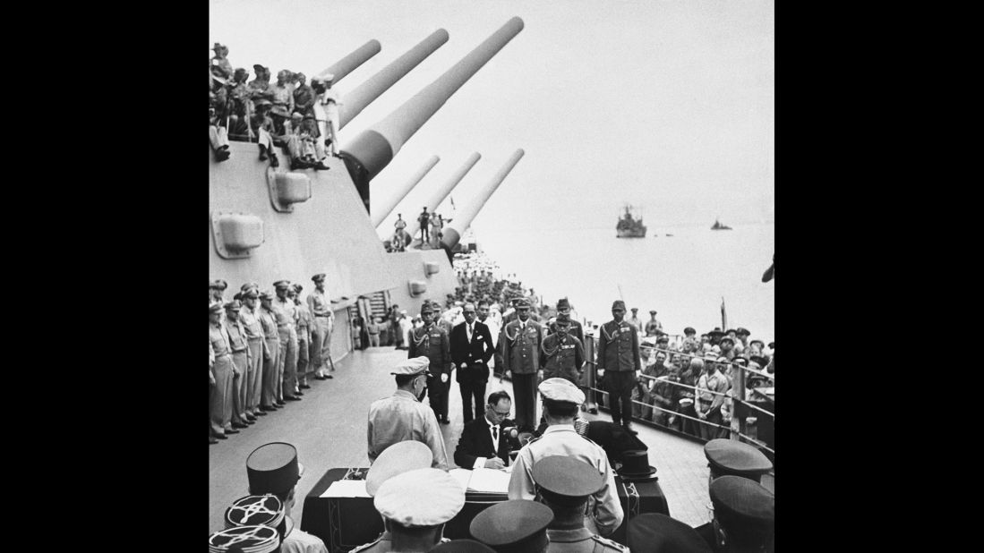 Japanese Foreign Minister Mamoru Shigemitsu signs the Japanese Instrument of Surrender on the deck of the battleship USS Missouri in Tokyo Bay on September 2, 1945, officially bringing World War II to an end. Overseeing the surrender is U.S. Gen. Douglas McArthur (right, back to camera).
