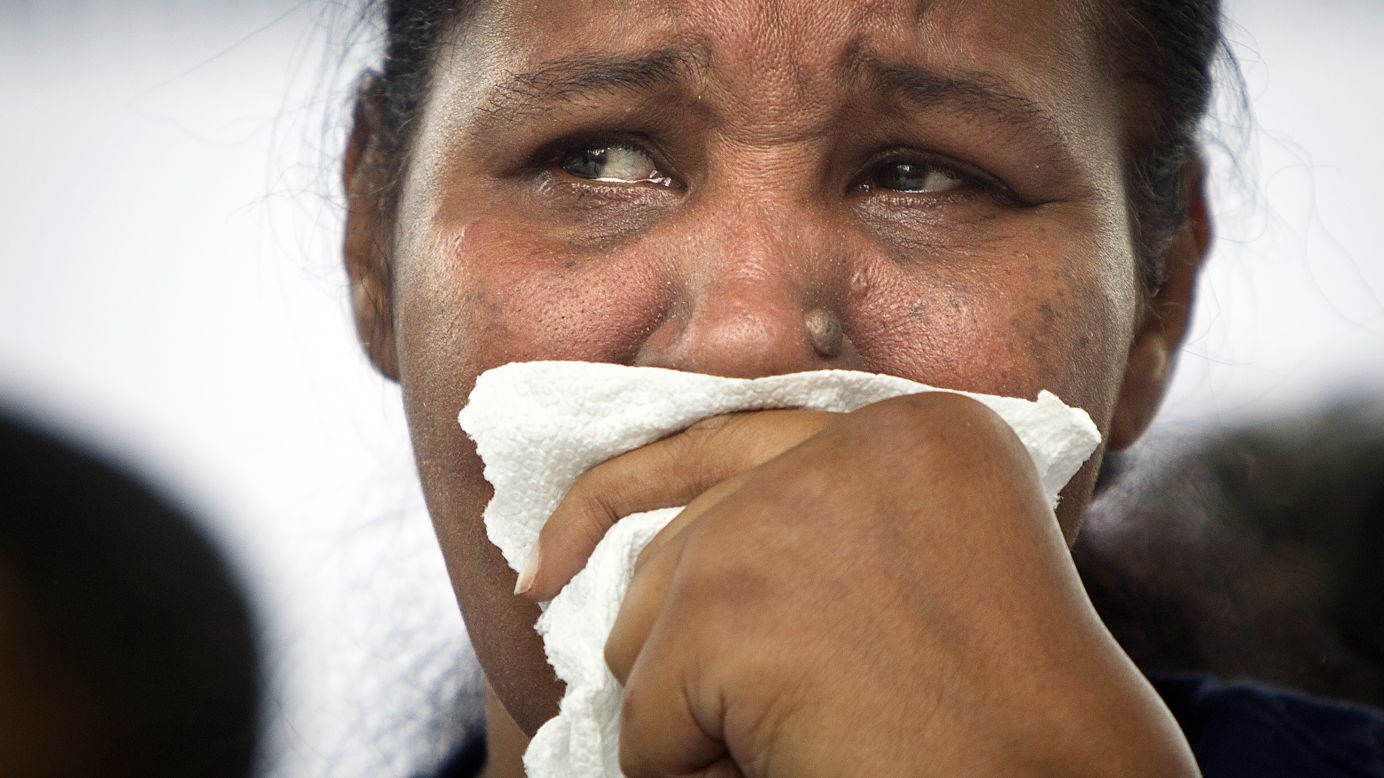 Widow Esaw Garner cries on stage during <a href="http://www.cnn.com/2014/08/23/us/new-york-choke-hold-rally/index.html">a rally for her husband</a> in Staten Island, New York, on Saturday, August 23. Eric Garner, an unarmed black man, died after a white police officer put him in a chokehold on July 17, sparking national outrage.