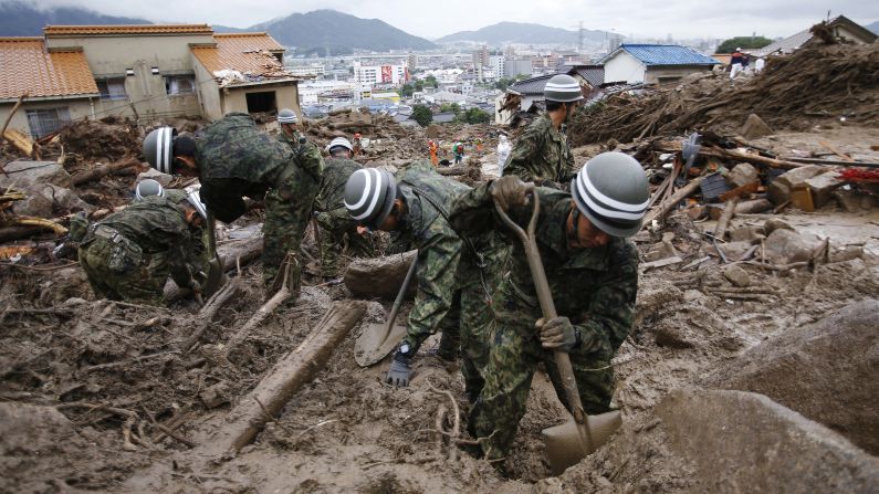 Japanese soldiers search for survivors on Friday, August 22, after <a href="http://www.cnn.com/2014/08/20/asia/gallery/hiroshima-landslide/index.html">rain triggered massive landslides</a> Wednesday that swallowed up dozens of homes in Hiroshima, Japan.