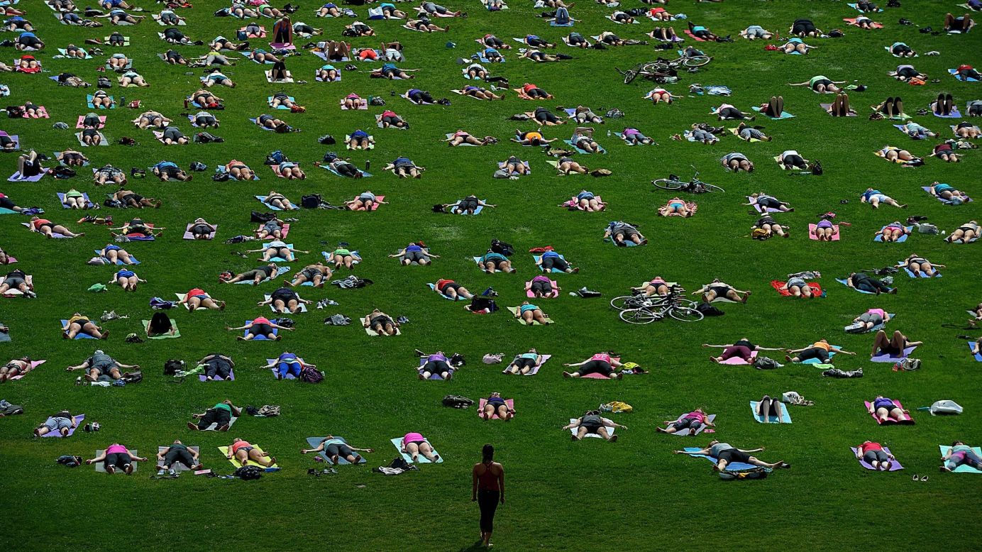 Dozens of people practice yoga on Parliament Hill in Ottawa, Ontario, on Wednesday, August 27.