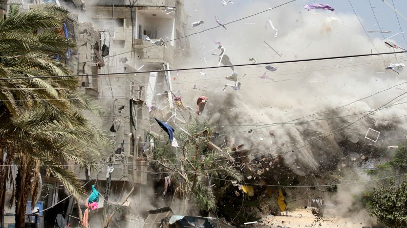 Smoke rises after Israeli aircraft hit a house in the Al-Shati refugee camp in Gaza on Sunday, August 24.