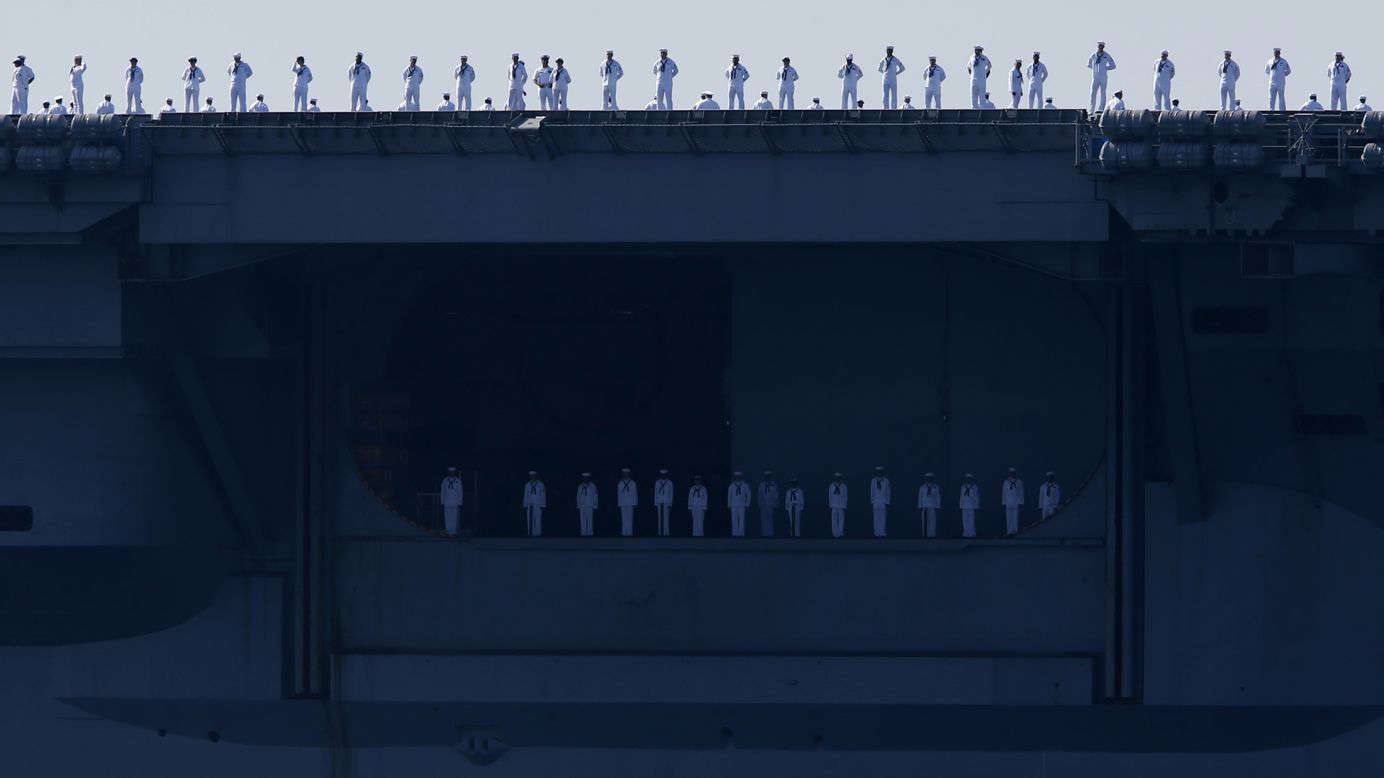 Sailors man the rails of the USS Carl Vinson aircraft carrier as it departs its home port in San Diego on Friday, August 22. The ship was deployed to the Western Pacific and Middle East.