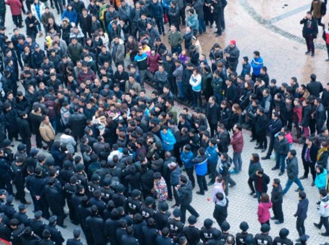 Factory workers rally in Zhejiang province in February following the closure of 4,500 factories that were violating safety regulations. (Getty Images)