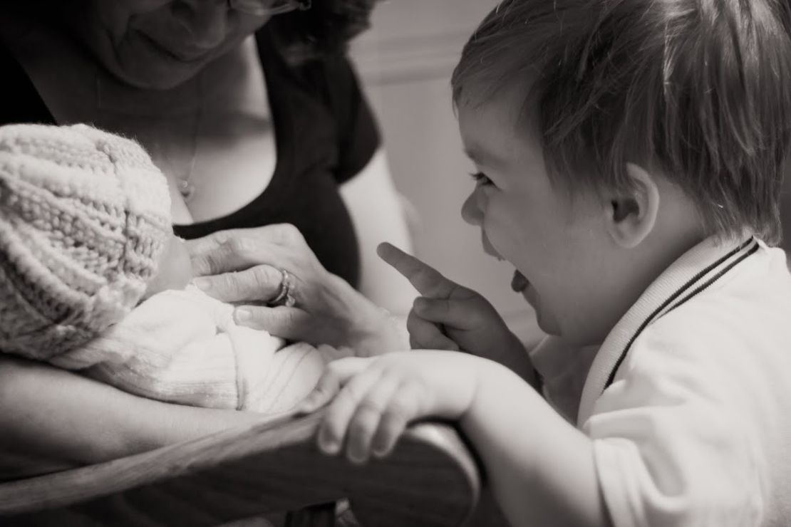 Stephanie Dulli's baby Piper, held by her grandmother, meets brother Huck