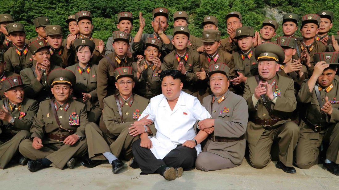 Kim poses for a photo as he oversees a tactical rocket-firing drill in June.