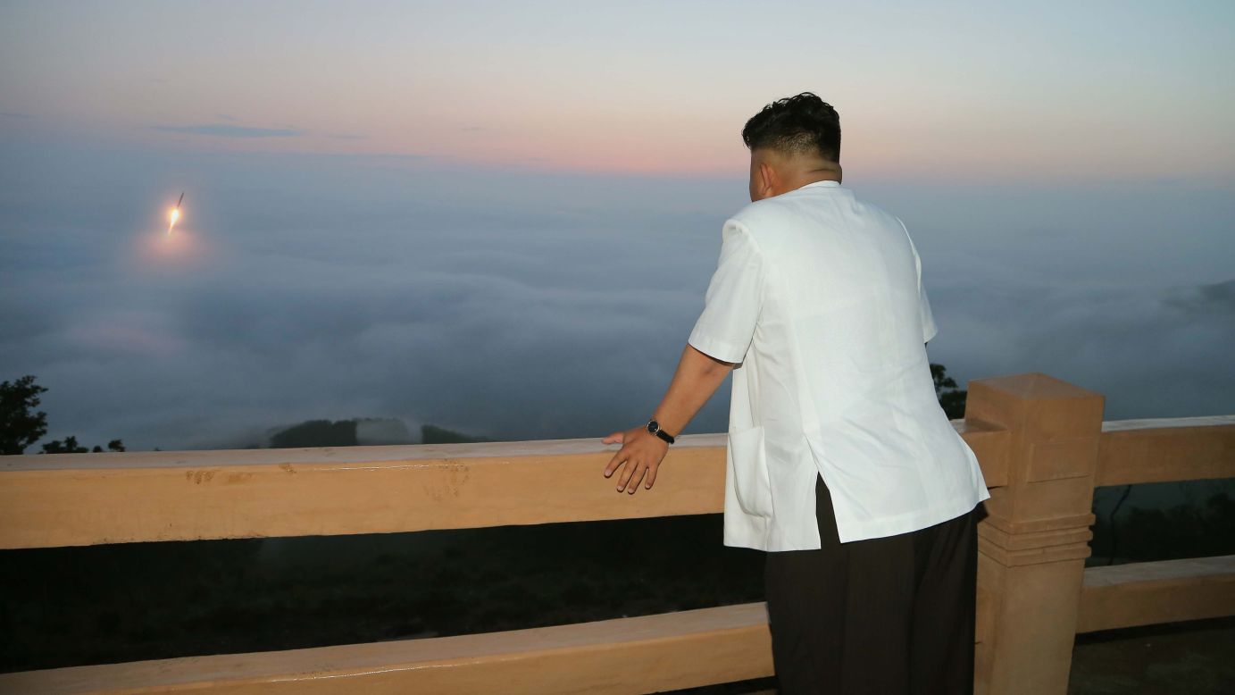 Kim watches a tactical rocket-firing drill in June.