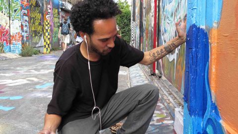 Artist Carlos Daniel Perez-Boza works on an authorized mural in the Mission District.