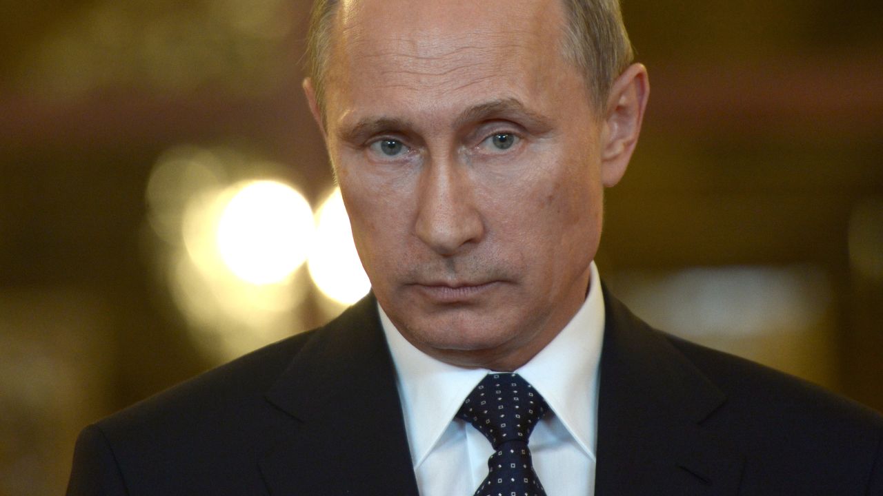 Caption:Russia's President Vladimir Putin looks on while speaking with journalists in Itamaraty Palace in Brazilia, early on July 17, 2014. The United States and Europe strengthened sanctions on Moscow over Ukraine yesterday, with President Barack Obama taking his first direct swipes in the finance, military and energy sectors of the Russian economy. Putin warned the biting sanctions will boomerang and hit back at US national interests, will inflicting 'very serious damage' on an already tattered US-Russia relationship. AFP PHOTO / RIA-NOVOSTI / POOL / ALEXEI NIKOLSKY (Photo credit should read ALEXEI NIKOLSKY/AFP/Getty Images)