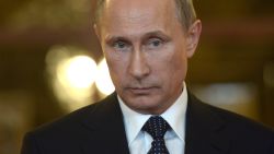 Caption:Russia's President Vladimir Putin looks on while speaking with journalists in Itamaraty Palace in Brazilia, early on July 17, 2014. The United States and Europe strengthened sanctions on Moscow over Ukraine yesterday, with President Barack Obama taking his first direct swipes in the finance, military and energy sectors of the Russian economy. Putin warned the biting sanctions will boomerang and hit back at US national interests, will inflicting 'very serious damage' on an already tattered US-Russia relationship. AFP PHOTO / RIA-NOVOSTI / POOL / ALEXEI NIKOLSKY (Photo credit should read ALEXEI NIKOLSKY/AFP/Getty Images)