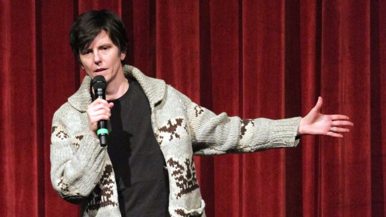 In August 2012, Tig Notaro did something that redefined what it means to be a woman in comedy. She took the stage at the Largo in Los Angeles for a stand-up set and opened with, "Good evening. Hello. I have cancer." Notaro had just been diagnosed with stage 2 cancer in both breasts, and, as she described to <a href="index.php?page=&url=http%3A%2F%2Fwww.newyorker.com%2Fculture%2Fculture-desk%2Fgood-evening-hello-i-have-cancer" target="_blank" target="_blank">The New Yorker</a>, "It felt so silly and irrelevant to think about ... observational jokes ... in light of what was going on with me." So instead, she turned her 30 minute set into a revolutionary performance on illness, pain and the human will -- showing in the process that sometimes the best comedy isn't the kind that makes you laugh, but connects you with others. 