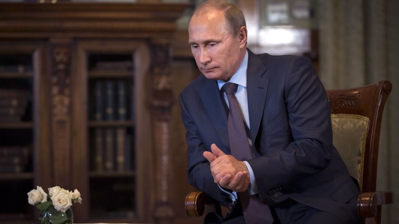 Caption:Russian President Vladimir Putin listens to French politician and businessman Philippe de Villiers (unseen) during their meeting at the Livadia Palace outside Yalta, Crimea, on August 14, 2014. De Villiers is set to build two history-themed amusement parks, one in Crimea and the other in Moscow. AFP PHOTO / POOL / ALEXANDER ZEMLIANICHENKO (Photo credit should read ALEXANDER ZEMLIANICHENKO/AFP/Getty Images)
