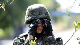 A member of Ukrainian volunteer battalion Dnipro looks through binoculars near the small southern Ukrainian city of Novoazovsk, Donetsk region, on August 27, 2014.