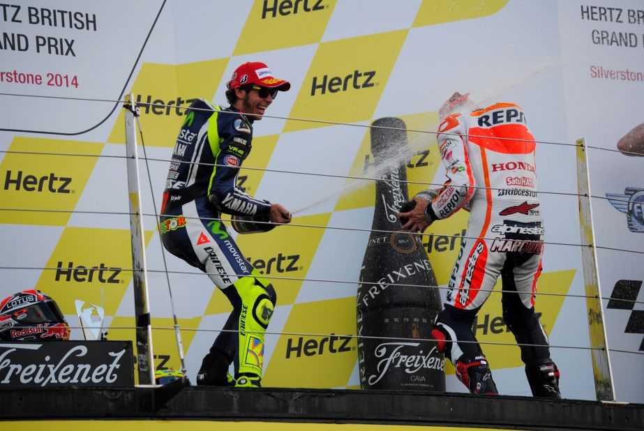 Rossi douses Marquez in champagne after the Spaniard's victory at the British MotoGP.