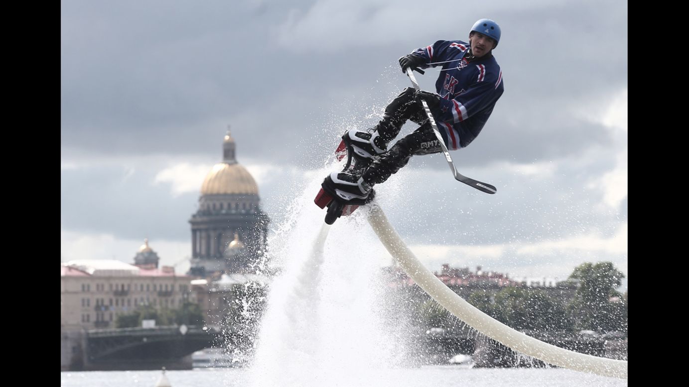 A man in a hockey uniform rides a flyboard Saturday, August 30, as the roster for SKA, a team in the Kontinental Hockey League, is unveiled in St. Petersburg, Russia.