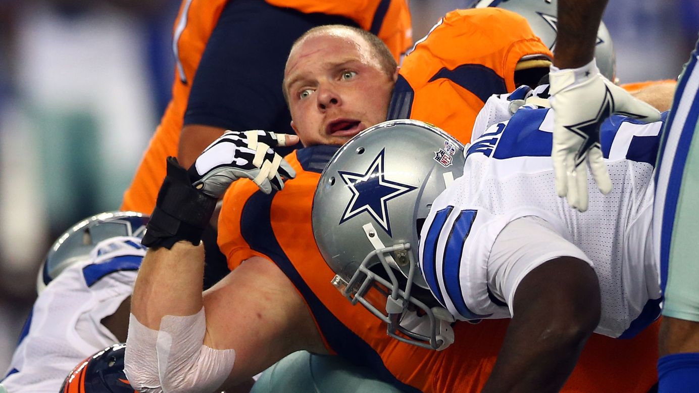 Denver's Will Montgomery loses his helmet after being hit by Dallas' Rolando McClain during an NFL preseason game Thursday, August 28, in Arlington, Texas.