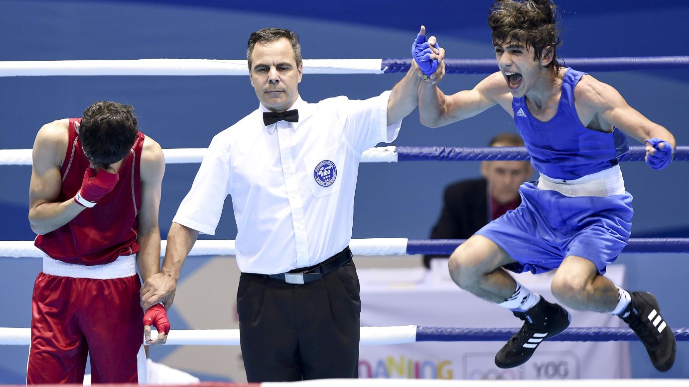 Boxer Rufat Huseynov of Azerbaijan celebrates after beating Uzbekistan's Sulaymon Latipov to win gold Wednesday, August 27, at the Youth Olympic Games in Nanjing, China.