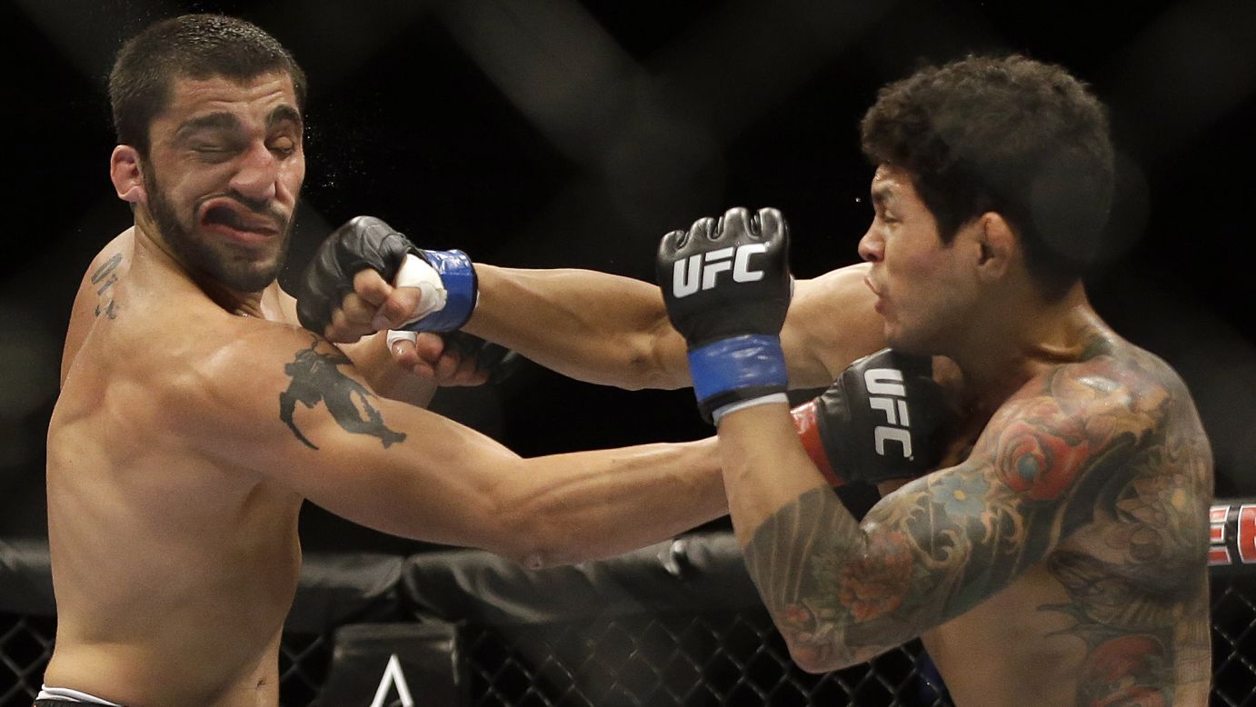 Diego Ferreira, right, punches Ramsey Nijem during their mixed martial arts bout Saturday, August 30, at UFC 177 in Sacramento, California. Ferreira won by a second-round knockout.