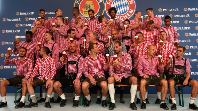 The Bayern Munich soccer team, wearing traditional Bavarian lederhosen, poses with Paulaner beers at a photo shoot Sunday, August 31, in Munich, Germany.