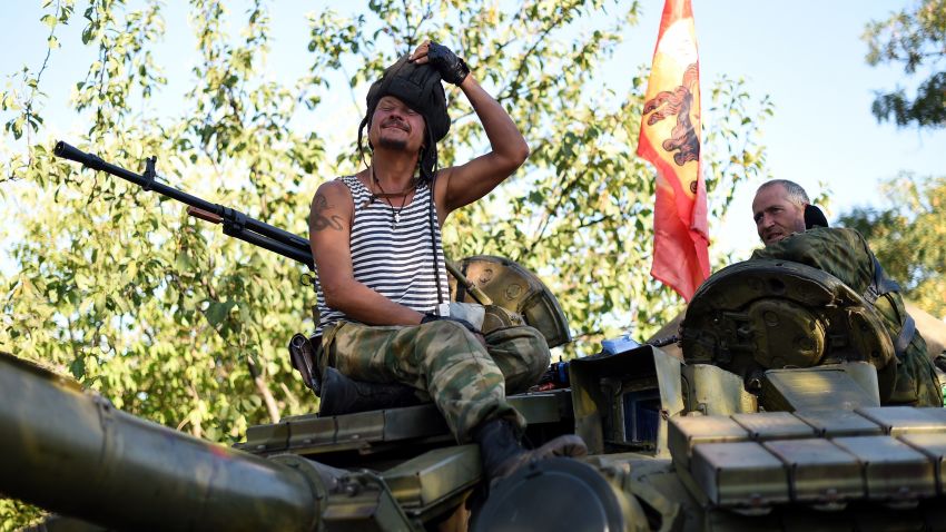 Pro-Russian fighters sit ontop of their T-64 tank in Starobesheve, southeast of Donetsk, on August 31, 2014.