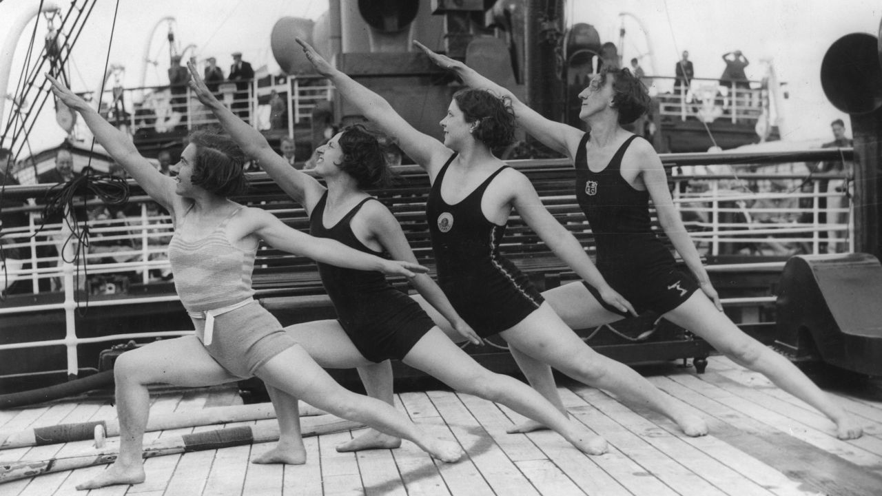 Four members of the LNER (London and North Eastern Railway) staff giving an athletic display in July 1933 on board the company's cruise liner, the SS Vienna.