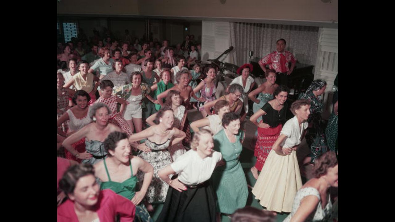 Women learn dance moves at a hula class in the main saloon on the SS Lurline during a 1954 voyage. The SS Lurline typically operated between San Francisco and Honolulu for the Matson cruise lines company. 