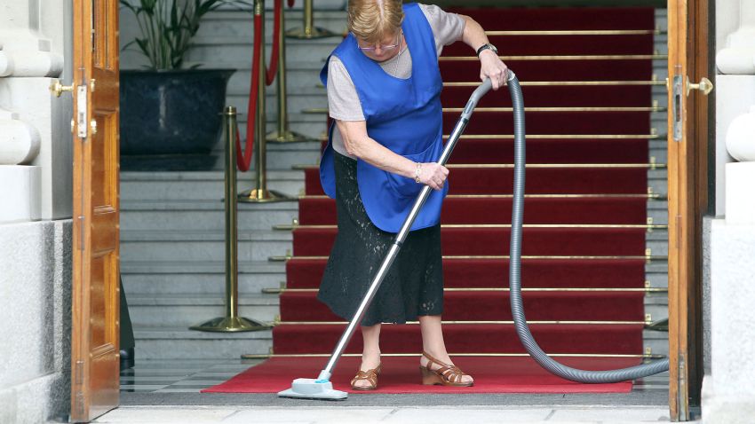 A lady hoovers the red carpet in advance of a visit by Queen Elizabeth II and Prince Philip, Duke of Edinburgh to some government buildings on May 18, 2011 in Dublin, Ireland. The Duke and Queen's visit to Ireland is the first by a monarch since 1911. An unprecedented security operation is taking place with much of the centre of Dublin turning into a car free zone. Republican dissident groups have made it clear they are intent on disrupting proceedings. (Photo by Irish Government - Pool/Getty Images)