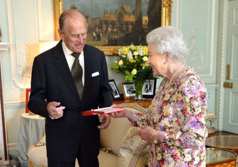 The Queen presents Prince Philip with New Zealand's highest honor, the Order of New Zealand, at Buckingham Palace in June 2013.