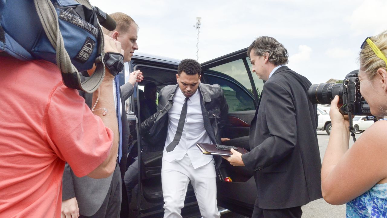 <strong>June 2014:</strong> The singer gets ready to enter a Washington courthouse for a hearing in his misdemeanor assault case stemming from an October 2013 sidewalk fight in the nation's capital. Brown rejected a plea deal at that time.
