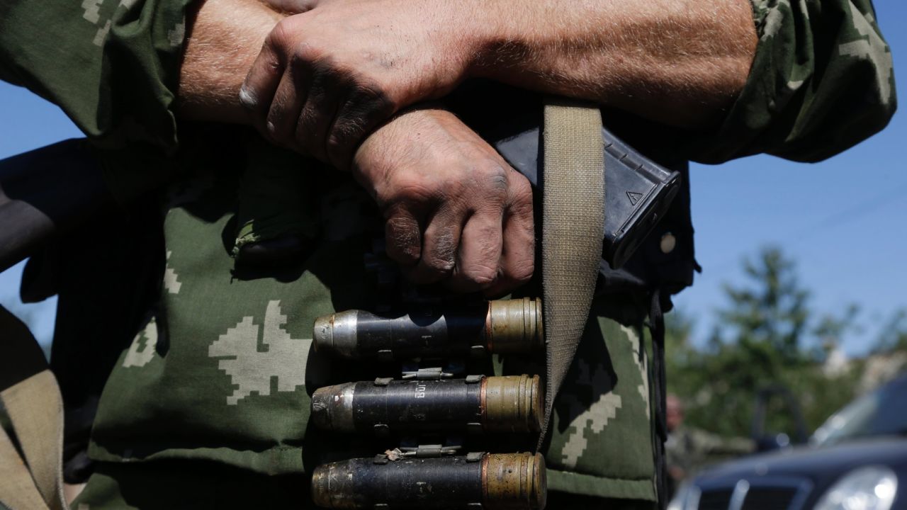 Pro-Russian rebel holds the ammo in the village of Hrabske, eastern Ukraine, Sunday, Aug. 31, 2014. The fight for Ilovaisk and surrounding areas, including the village of Hrabske, between Ukrainian government troops and pro-Russian separatist fighters was bitter and lasted the best part of a month. (AP Photo/Sergei Grits)