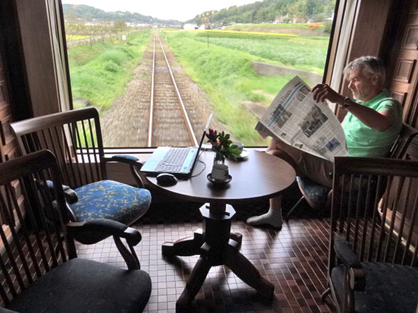 The back end of the carriage is a giant floor-to-ceiling window, like a flickering movie screen on which the passing landscapes are act out their various parts