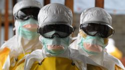 Caption:Health care workers, wearing protective suits, leave a high-risk area at the French NGO Medecins Sans Frontieres (Doctors without borders) Elwa hospital on August 30, 2014 in Monrovia. Liberia has been hardest-hit by the Ebola virus raging through west Africa, with 624 deaths and 1,082 cases since the start of the year. AFP PHOTO / DOMINIQUE FAGET (Photo credit should read DOMINIQUE FAGET/AFP/Getty Images)