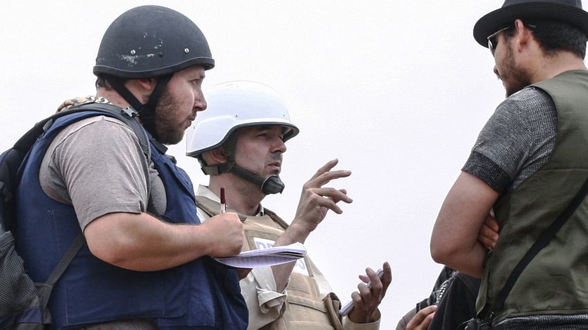 In this handout image made available by the photographer American journalist Steven Sotloff, left, talks to Libyan rebels on the Al Dafniya front line in Misrata, Libya, in June 2011.
