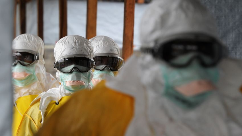 Health care workers, wearing protective suits, leave a high-risk area at the French NGO Medecins Sans Frontieres (Doctors without borders) Elwa hospital on August 30, 2014 in Monrovia.