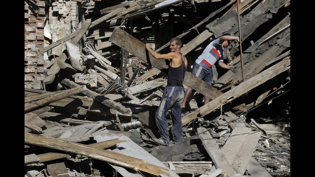 Men clear rubble in Ilovaisk, Ukraine, on Sunday, August 31.