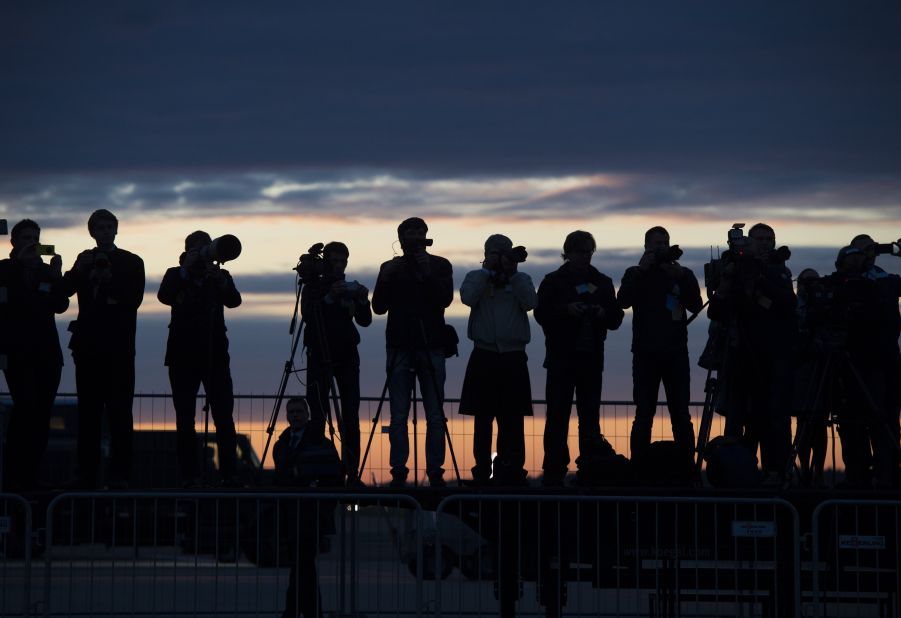 Estonian press photographers cover Obama's arrival at Tallinn Airport early on September 3.