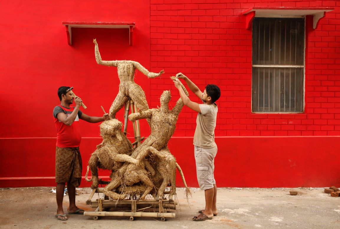 SEPTEMBER 3 - ALLAHABAD, INDIA: Indian artisans prepare an idol of the Hindu goddess Durga slaying the demon Asura for the upcoming Durga Puja festival -- <a href="http://timesofindia.indiatimes.com/life-style/fashion/trends/Fashion-forward-for-the-Durga-Puja-season/articleshow/41617906.cms" target="_blank" target="_blank">Bengal's biggest event of the year.</a>