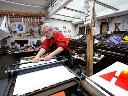 Alan Kitching at work on his Monotype prints in his London workshop. - (Courtesy Phil Sayer)