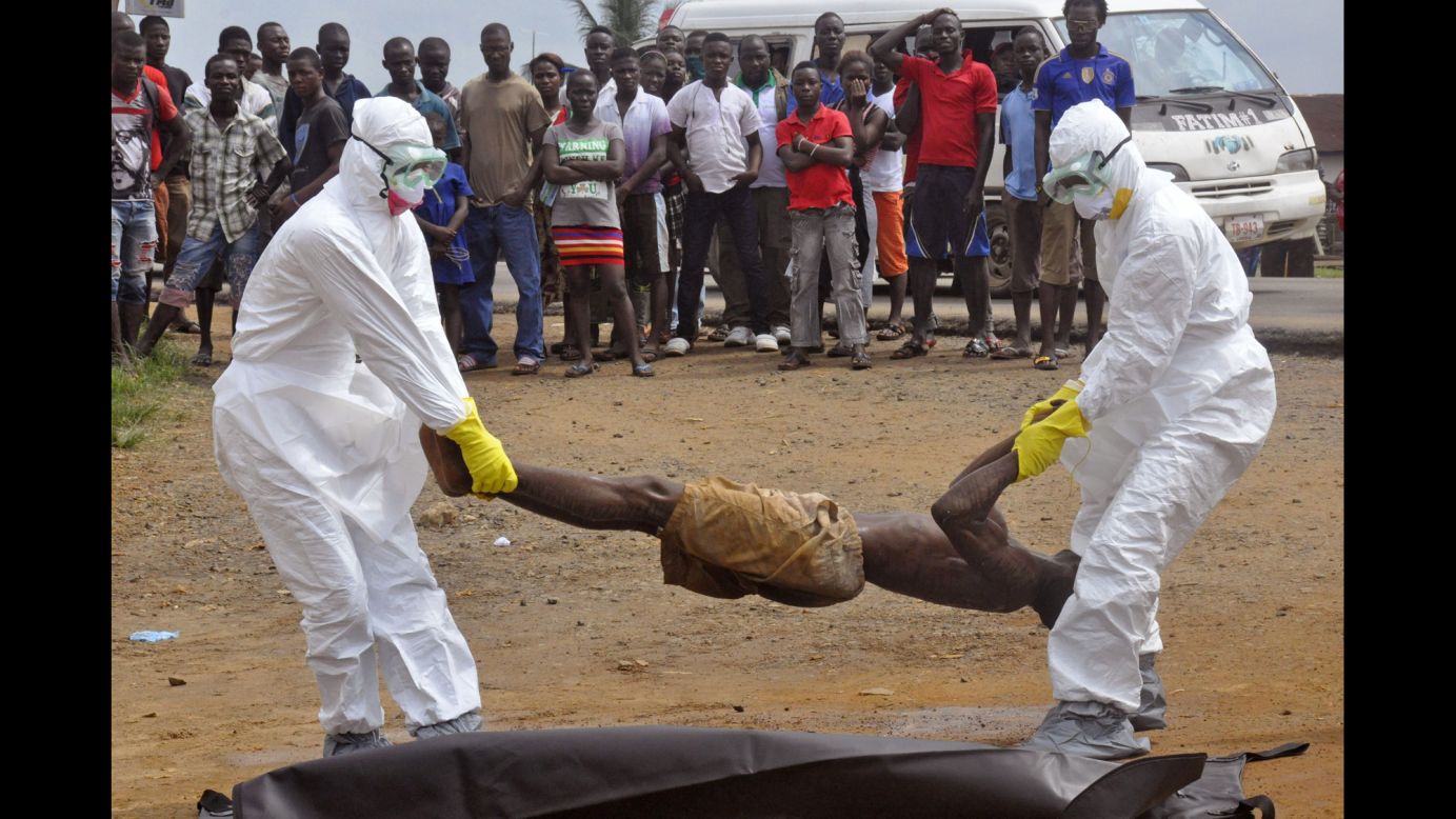 Health workers place a corpse into a body bag Thursday, September 4, in Monrovia, Liberia. The suspected cause of death was the Ebola virus, which has killed more than 1,900 people in West Africa since December, according to the World Health Organization. Health officials say <a href="http://www.cnn.com/2014/04/04/world/gallery/ebola-in-west-africa/index.html">the current Ebola outbreak</a> is the deadliest ever.