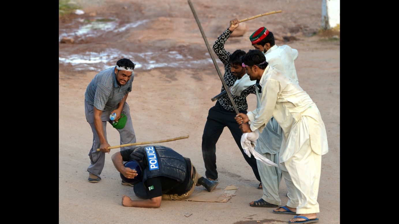 Supporters of politician Imran Khan and cleric Tahir ul-Qadri beat a riot policeman during an anti-government protest in Islamabad, Pakistan, on Monday, September 1. Thousands of protesters, demanding the resignation of Pakistani Prime Minister Nawaz Sharif, <a href="http://www.cnn.com/2014/09/01/world/asia/pakistan-protests/index.html">have been battling police and soldiers</a> for weeks.