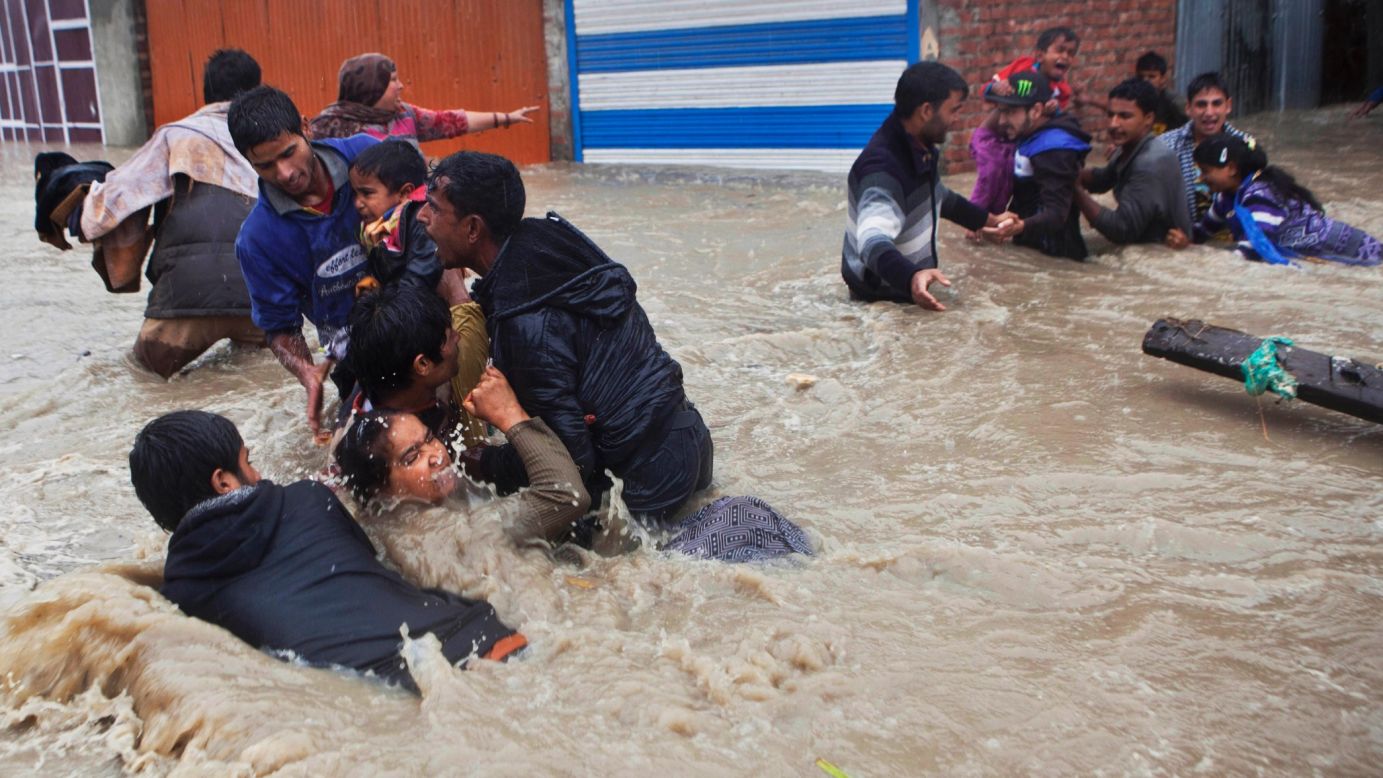 People struggle to wade through floodwaters Thursday, September 4, in Srinagar, India. Many villages and urban areas in Indian-administered Kashmir <a href="http://www.cnn.com/2014/09/04/world/asia/india-bus-accident/index.html">have been flooded</a> after heavy rain made lakes and rivers overflow.