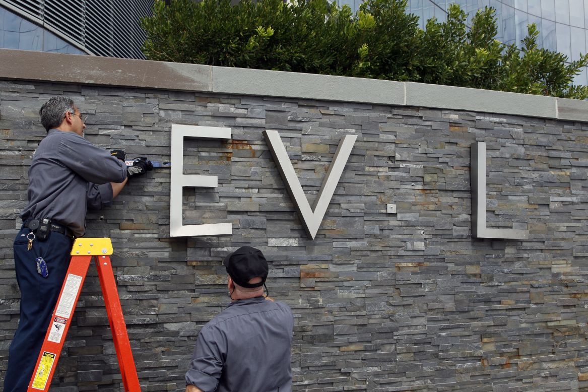 Employees of the Revel Casino Hotel remove signage from its wall along the boardwalk in Atlantic City, New Jersey, on Monday, September 1. Revel closed the next day after its second bankruptcy since opening in 2012.