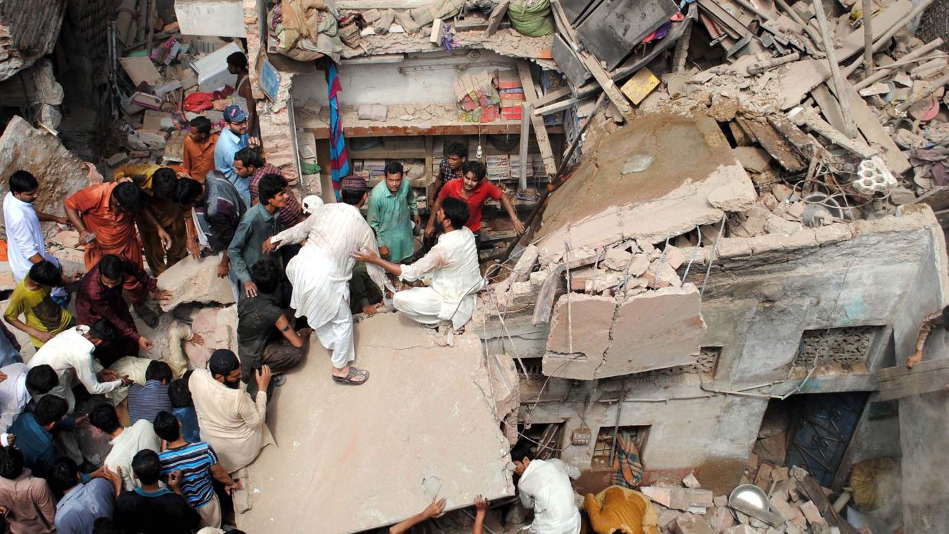 Rescuers work at the site of a residential building collapse in Hyderabad, Pakistan, on Tuesday, September 2. 