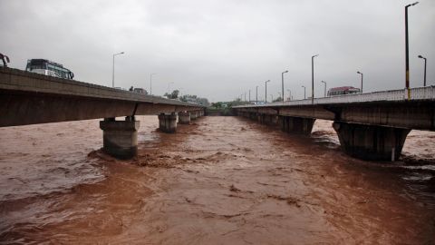 Floodwaters inch higher on a bridge September 5 in Jammu.