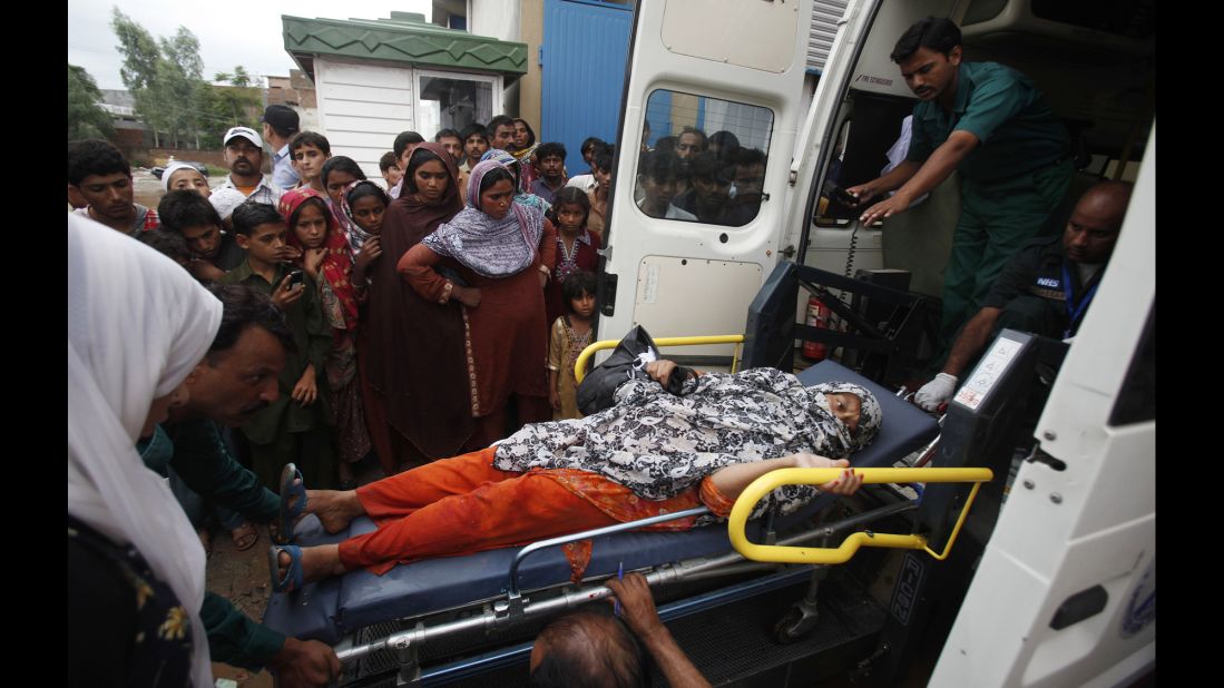 An injured woman is loaded into an ambulance after being rescued from a flooded area of Islamabad on September 5.
