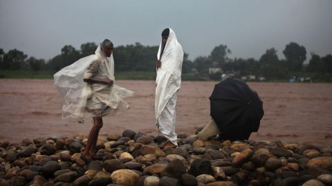 Residents watch water levels rise on the banks of the River Tawi in Jammu on September 4.