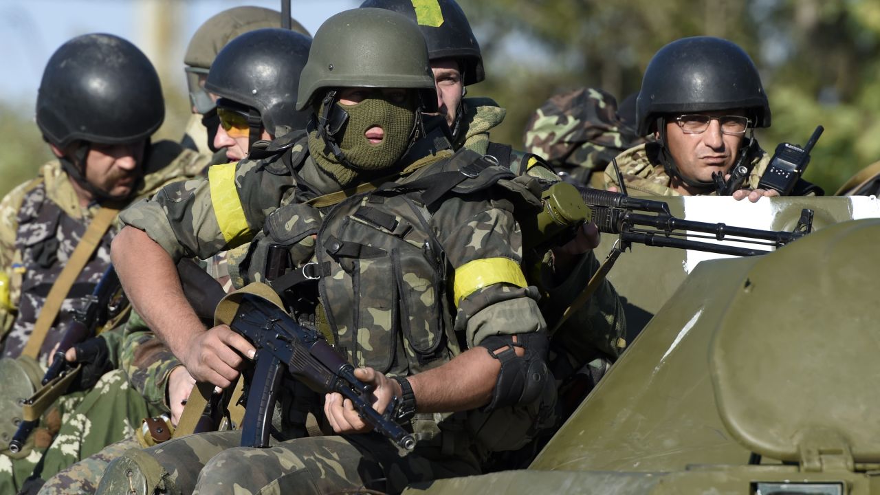 Caption:Ukrainian army soldiers go to the front line on an armoured vehicle as pro-Russian separatists fire heavy artillery, on the outskirts of the key southeastern port city of Mariupol, on September 5, 2014. NATO leaders are expected to announce a raft of fresh sanctions against Russia on Friday over its actions in Ukraine, although hopes remain that a ceasefire can be forged at peace talks in Minsk on the same day. AFP PHOTO/PHILIPPE DESMAZES (Photo credit should read PHILIPPE DESMAZES/AFP/Getty Images)