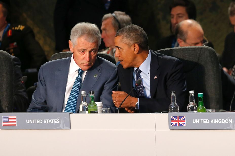 Obama speaks with Defense Secretary Chuck Hagel at a meeting on the future of NATO on September 5.