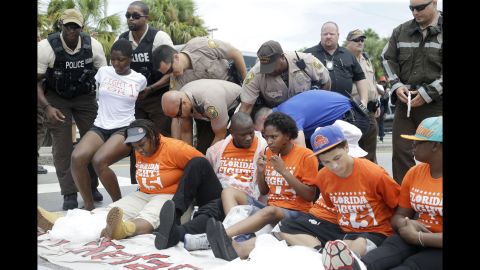 Police officers arrest a group of demonstrators that were blocking a road in North Miami Beach, Florida, on September 4.