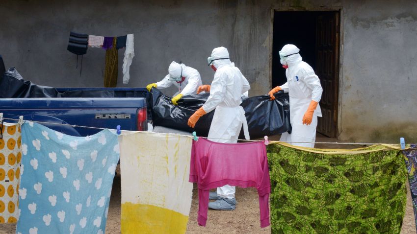 Medical workers of the Liberian Red Cross, wearing protective clothing, carry the body of a victim of the Ebola virus in a bag on Thursday, September 4, in the small city of Banjol, Liberia, about 20 miles from the capital of Monrovia.